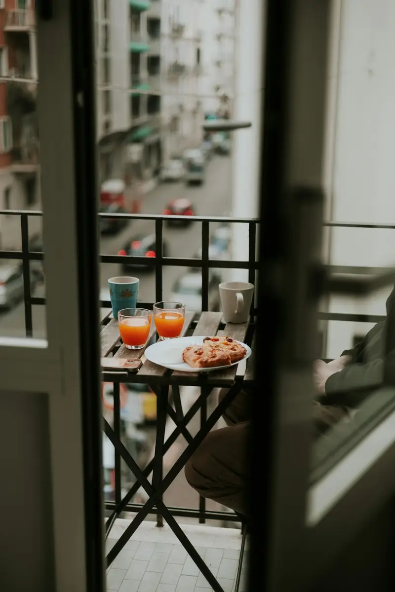 Breakfast on a balcony overlooking a city street