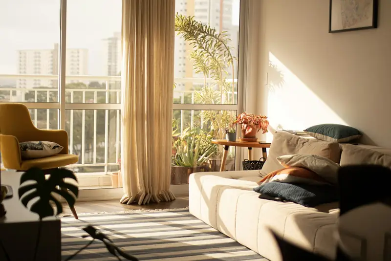 Bright apartment living room with large windows and linen curtains